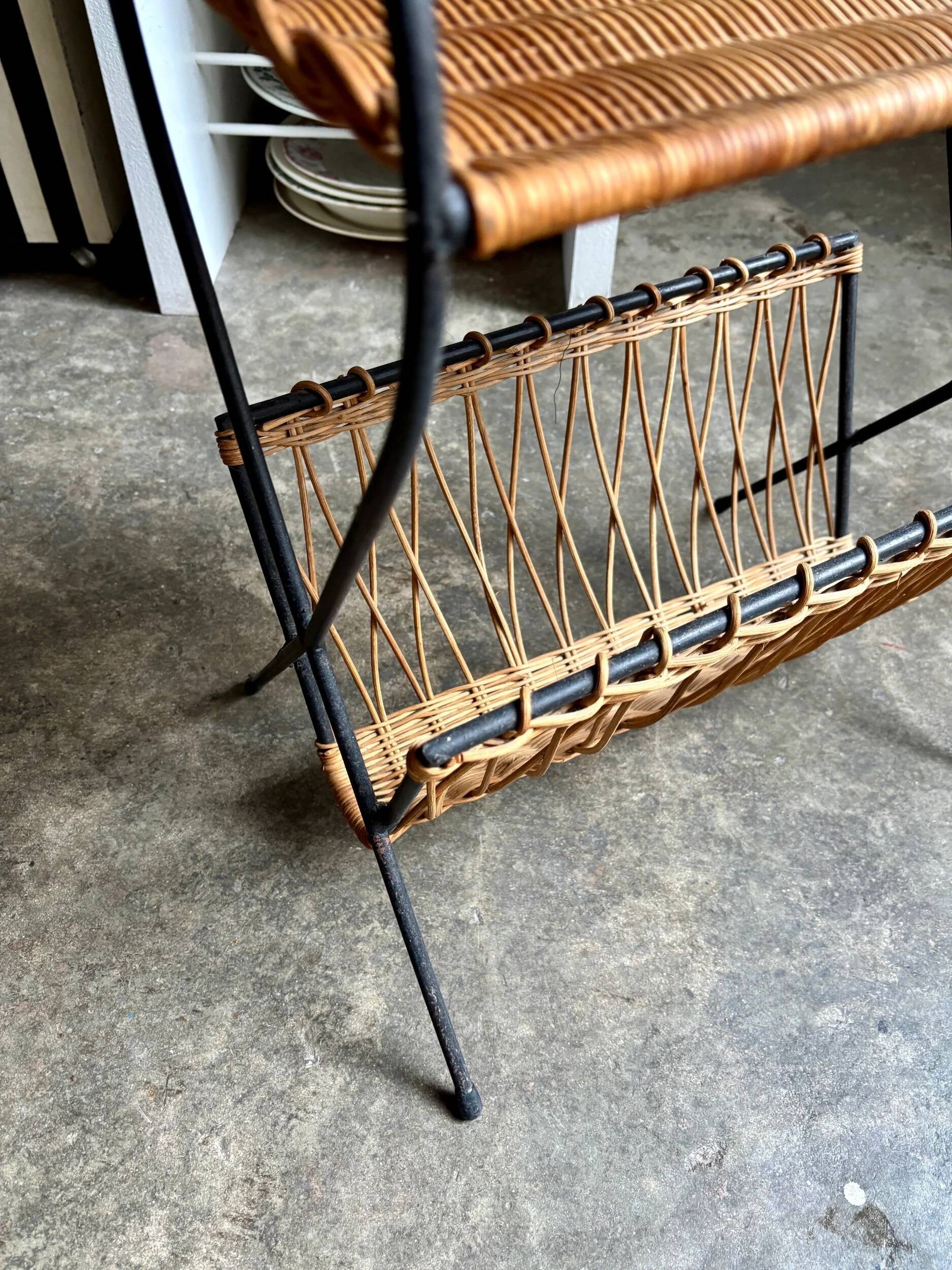 Black metal and woven wicker magazine rack