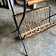 Black metal and woven wicker magazine rack