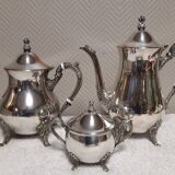 Silver-plated coffee and tea service including a coffee pot, a teapot, and a sugar bowl.