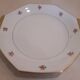 Hexagonal plate Lamotte with a double gold border, decorated with small bouquets.