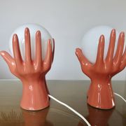 Pair of salmon-colored ceramic "hand" lamps with opaline globe, 80