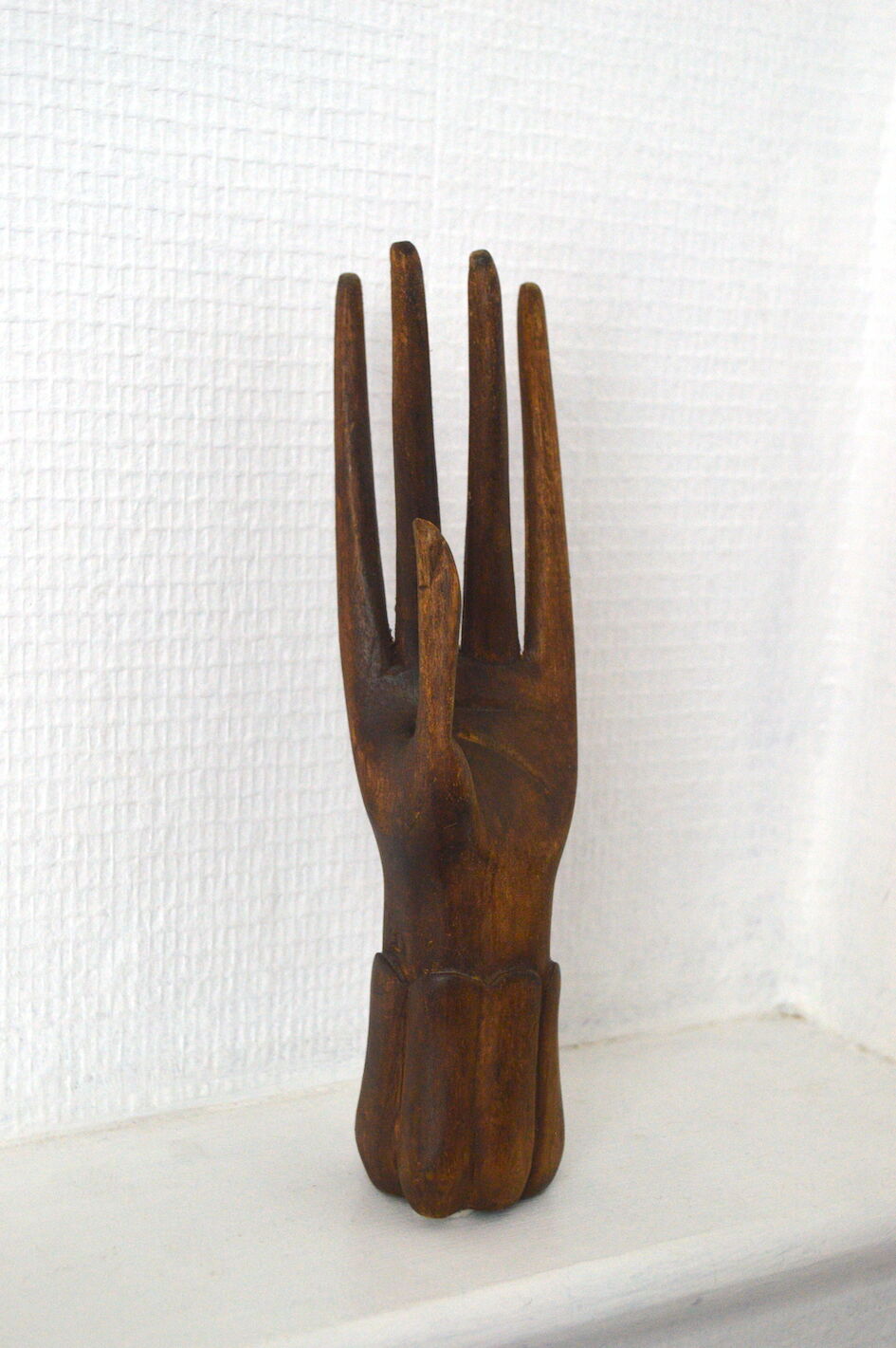 Carved wooden baguier hand
