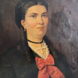 Old oil painting on canvas portrait of a woman with a red bow, late 19th century
