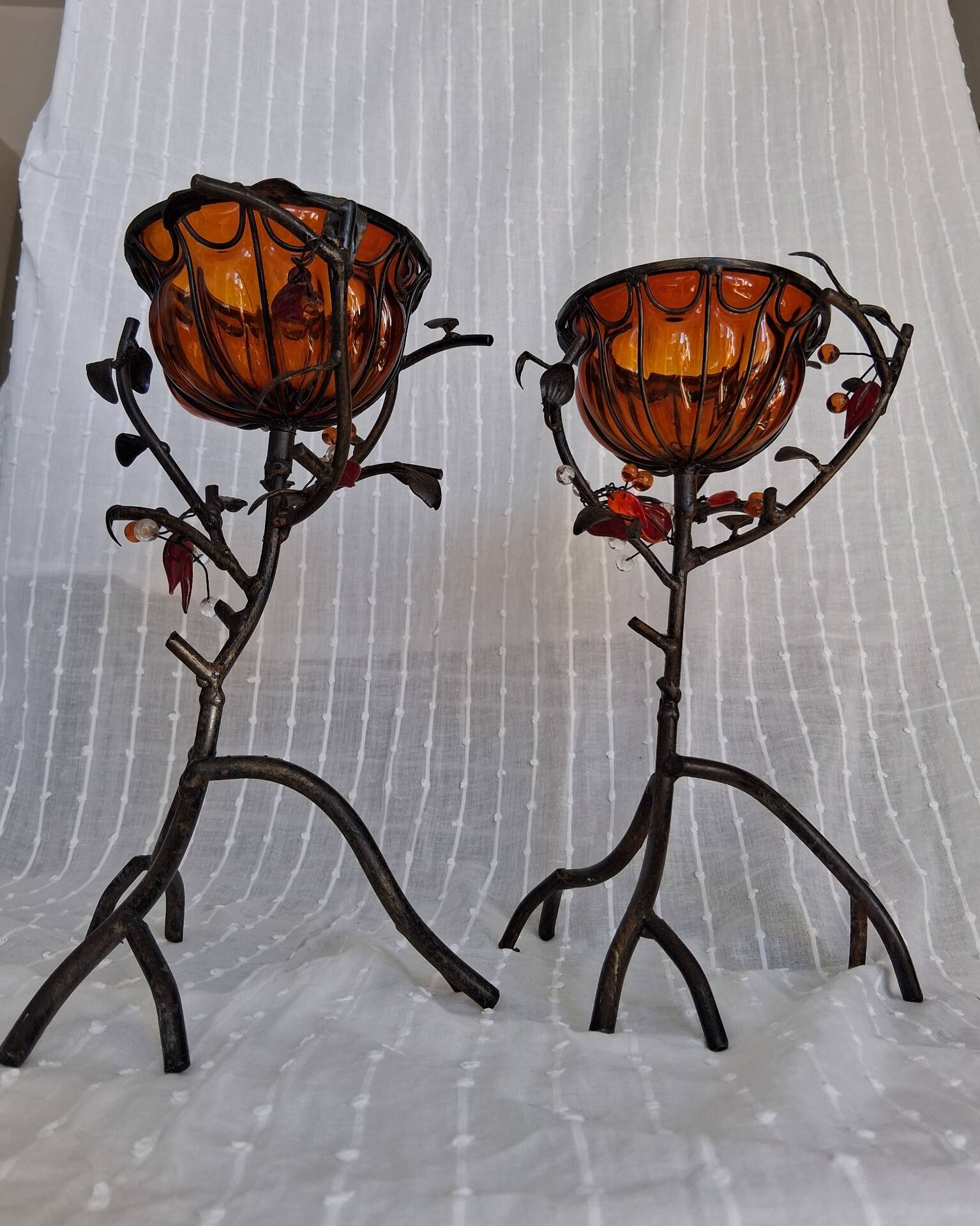 Pair of Art Deco style candle holders in wrought iron and amber blown glass.