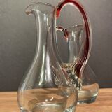 pair of crystal buires, handles with red tinted net decoration in the mass