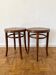 2 antique bistro stools with curved wood and caning effect.