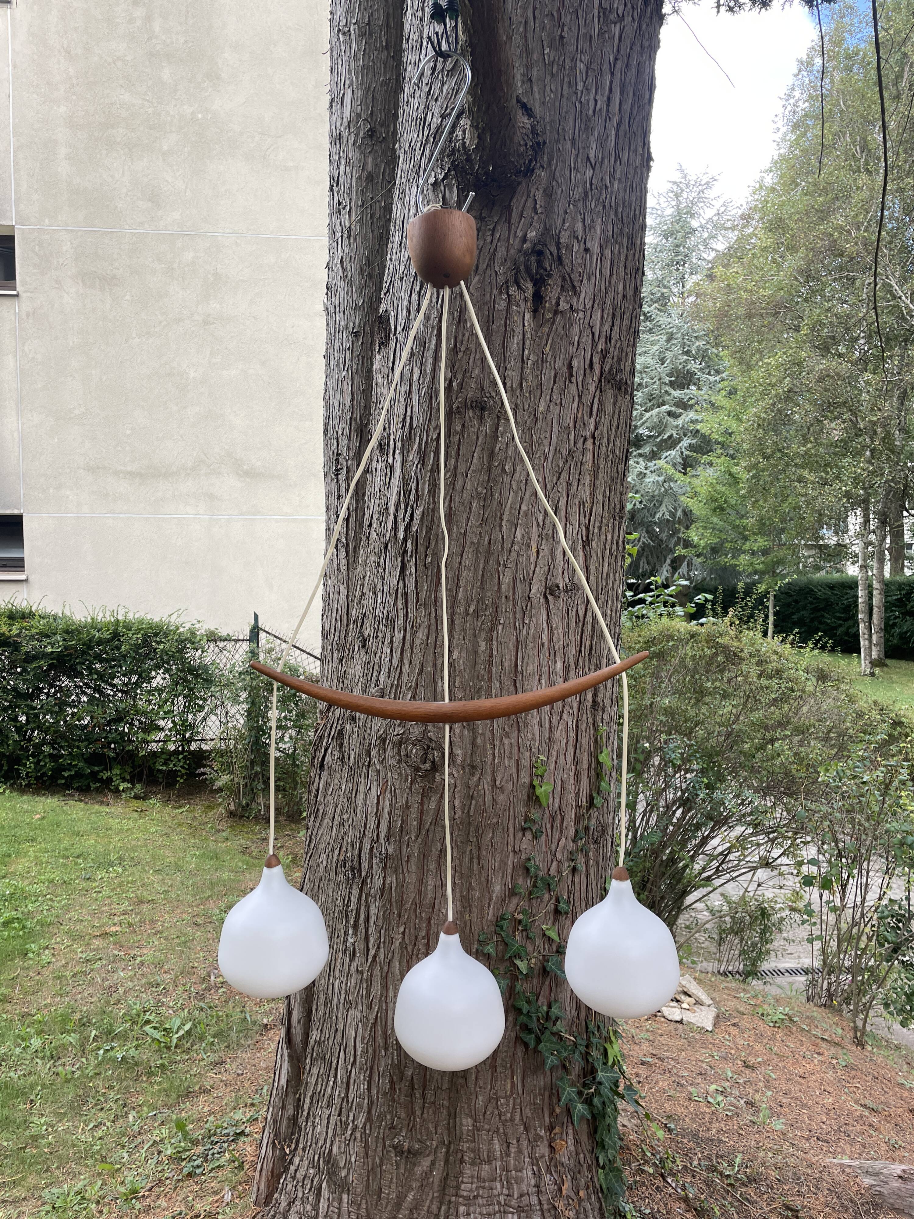 Scandinavian triple pendant light in Opaline and oak by Uno & Östen Kristiansson.
