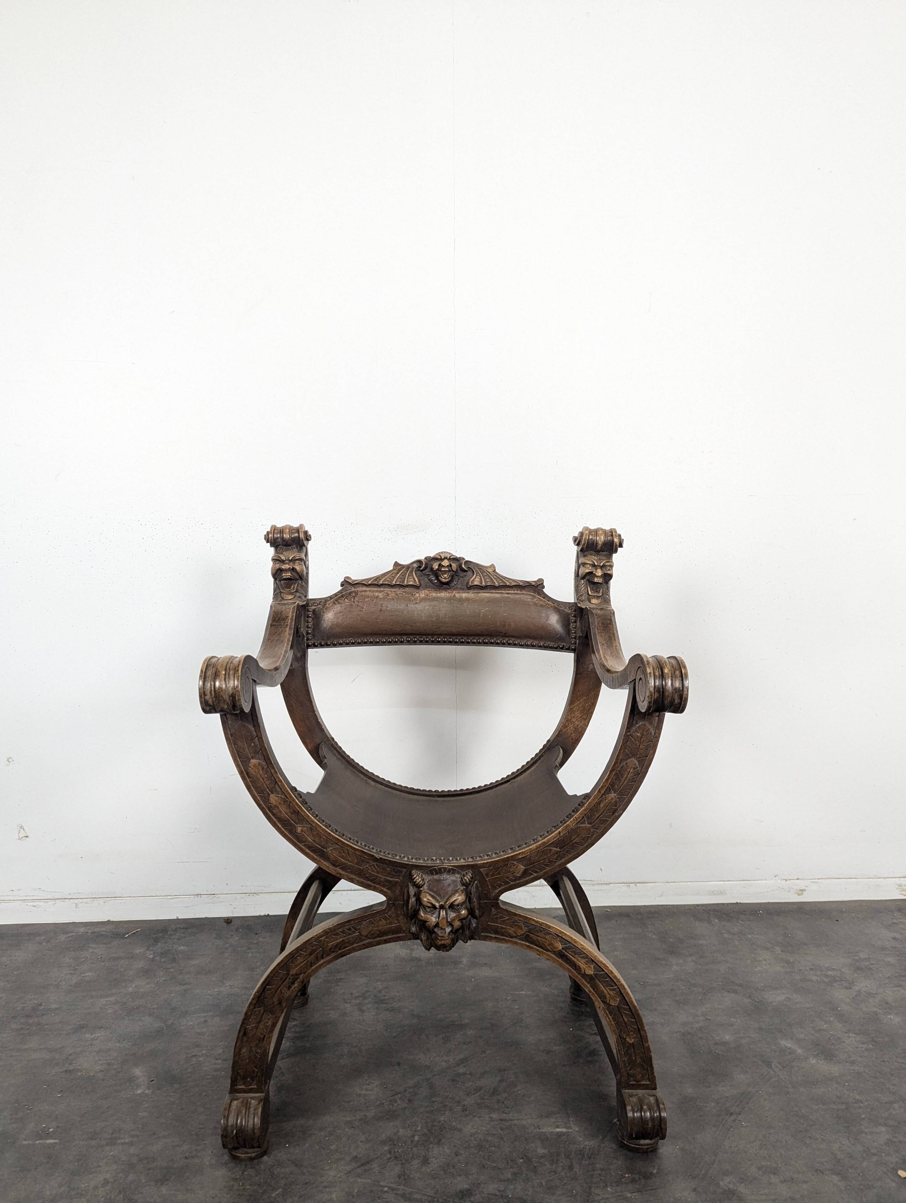 Curule chair Dagobert in carved walnut with lion heads.