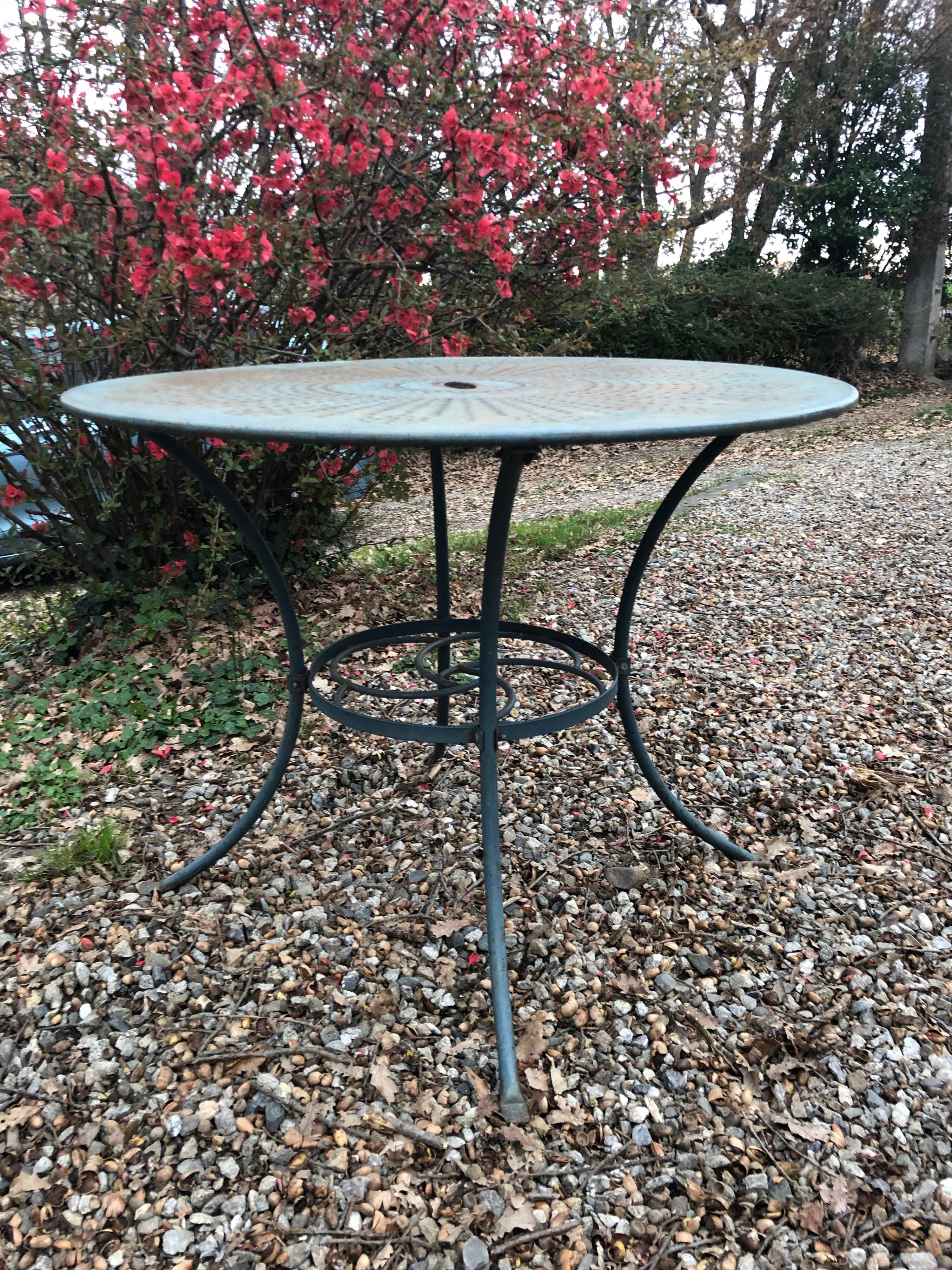 Green wrought-iron garden table round