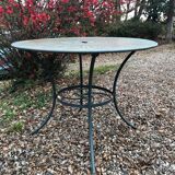 Green wrought-iron garden table round