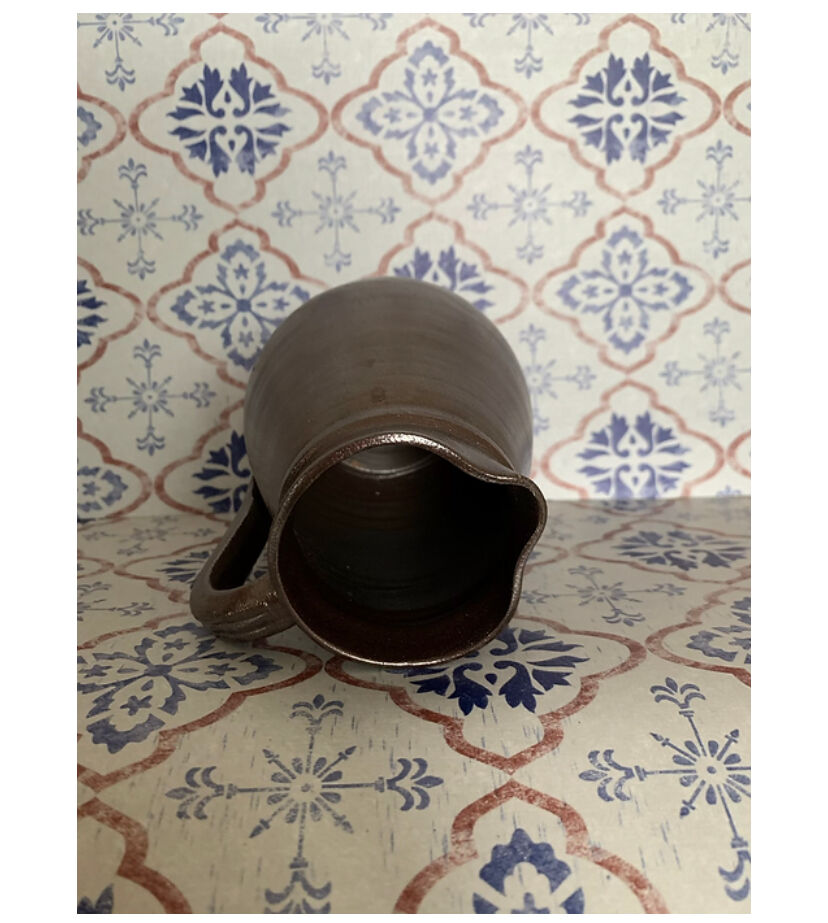 Pitcher in dark brown sandstone