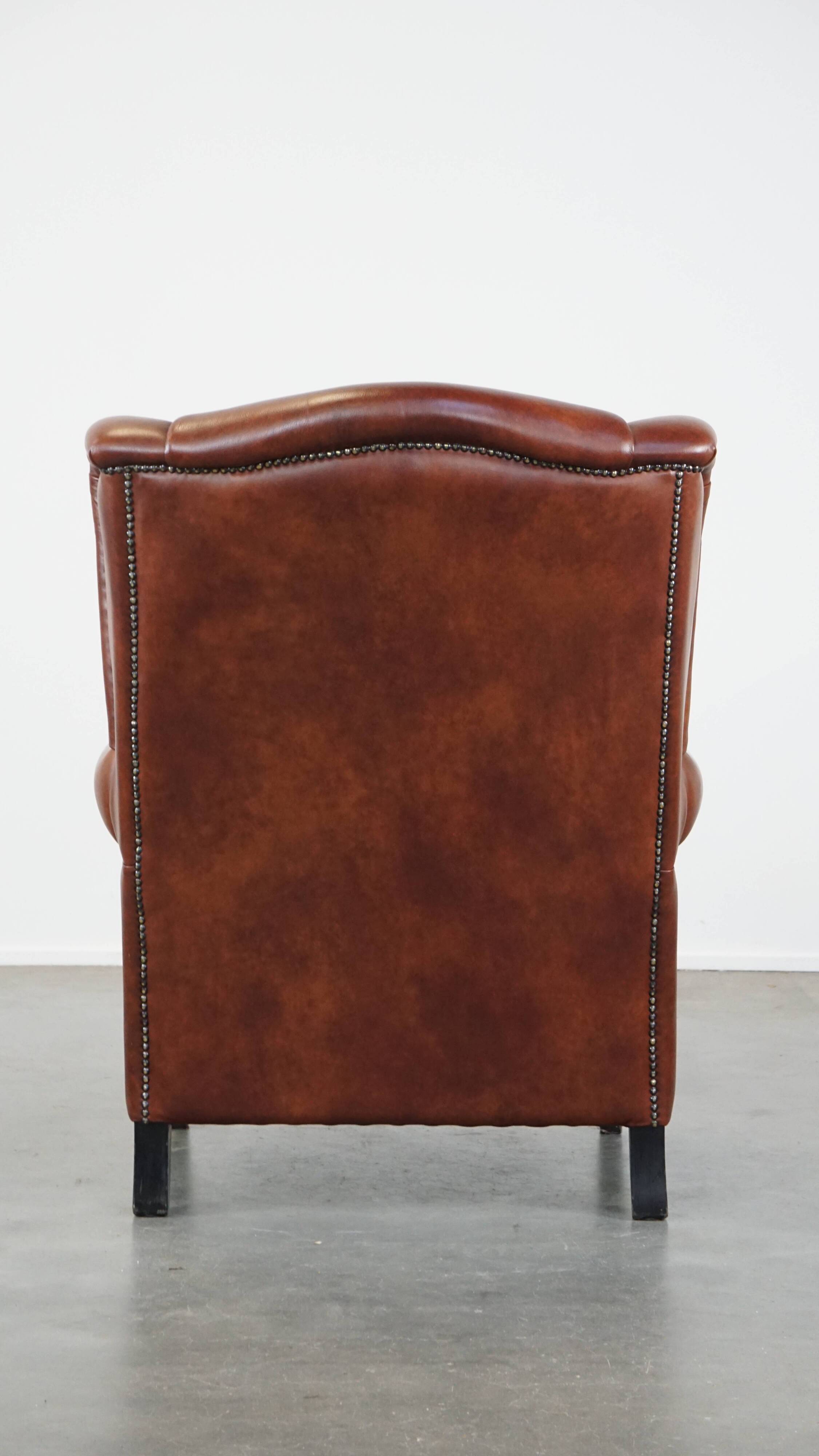 Cognac-colored cowhide wingback chair