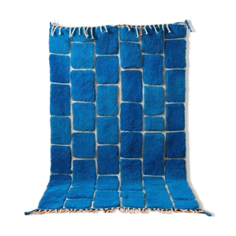 Handmade traditional pure wool carpet with blue patterns.