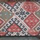 Victorian canapé upholstered in Kilim with turned mahogany legs.