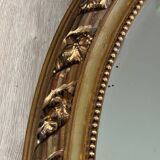 19th century oval gilded mirror, torch & quiver 106cm