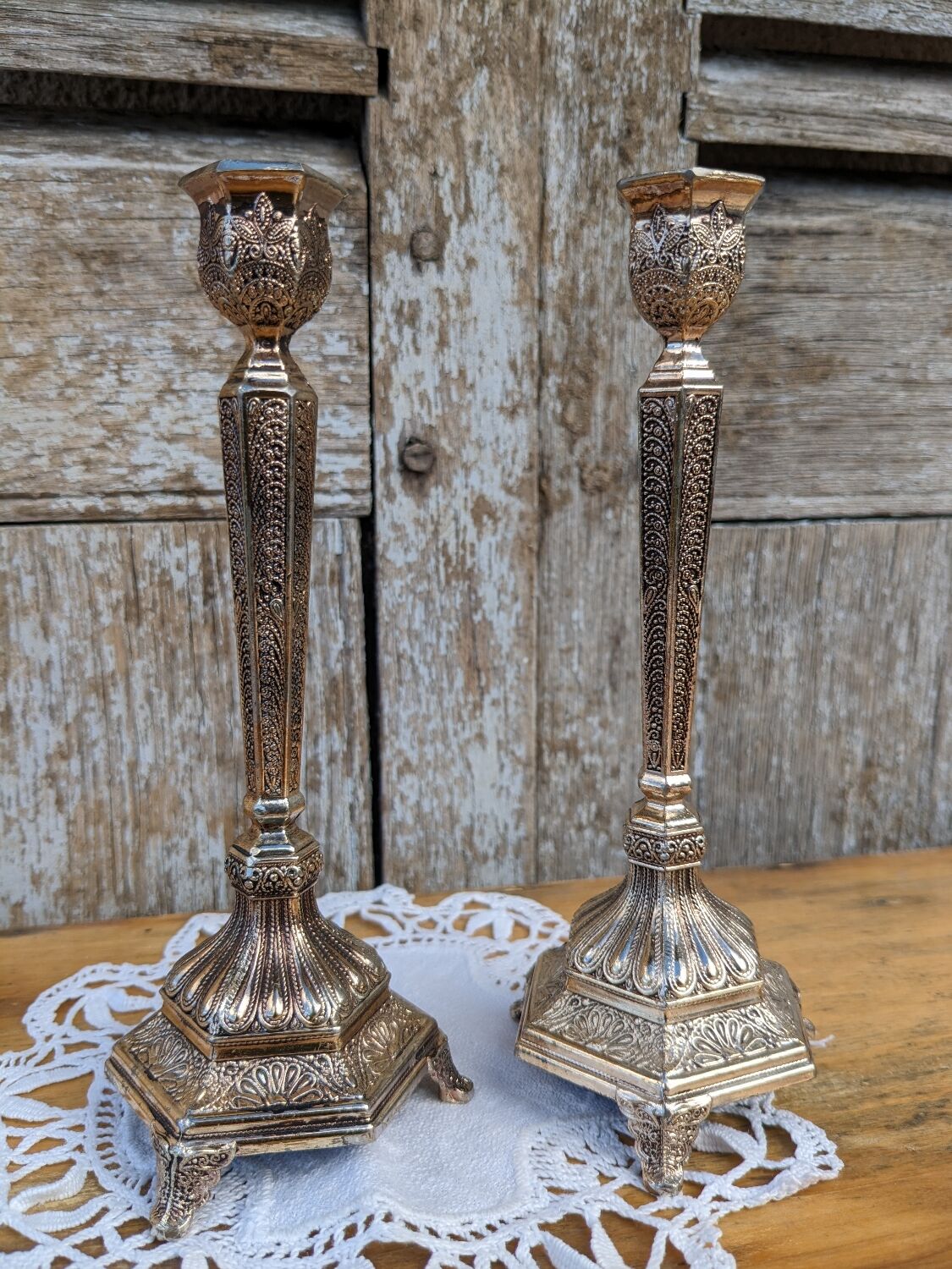 Pair of chiseled metal candle holders