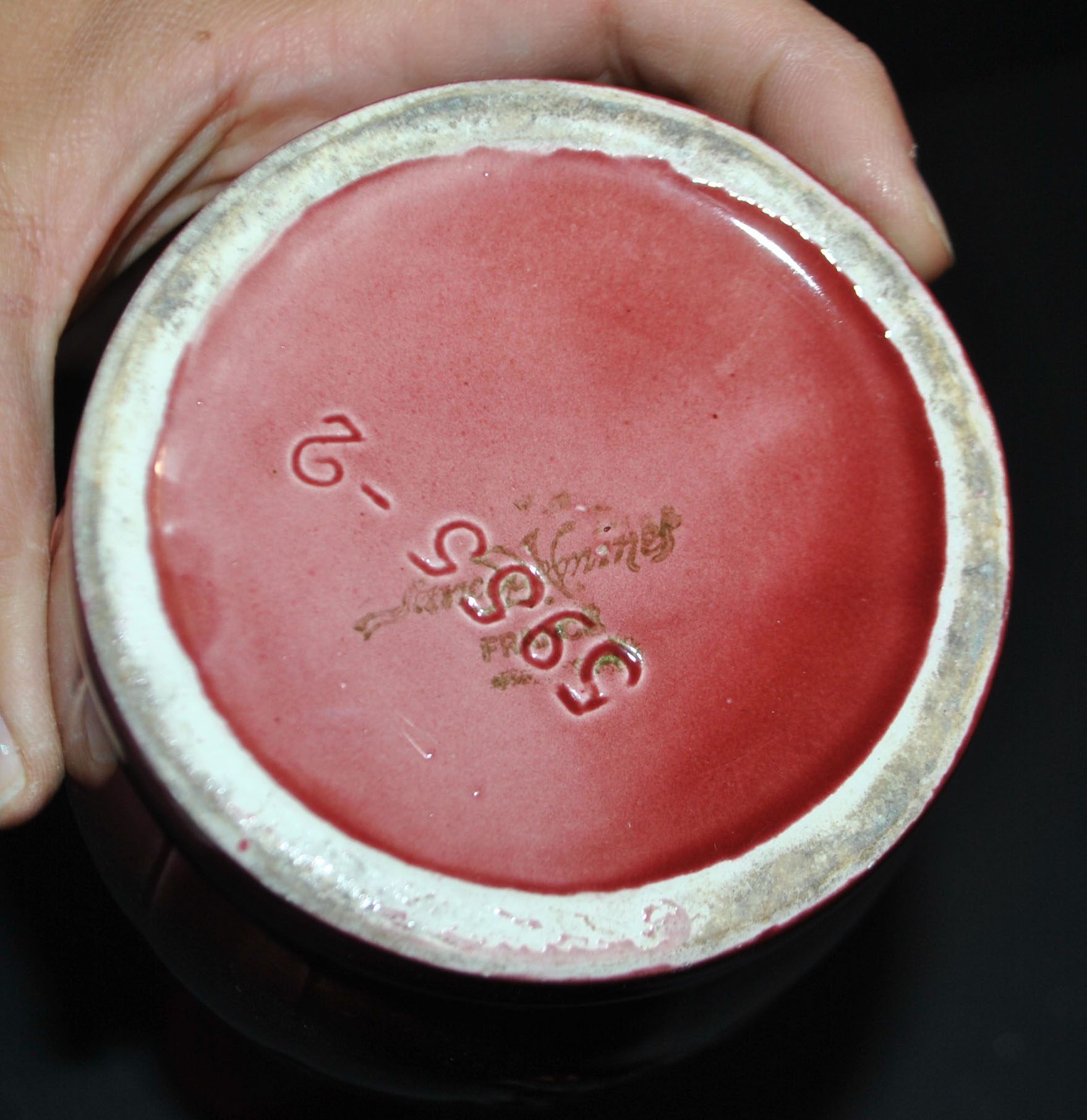 Sarreguemines wine jug in red slipware with grapevine decoration.