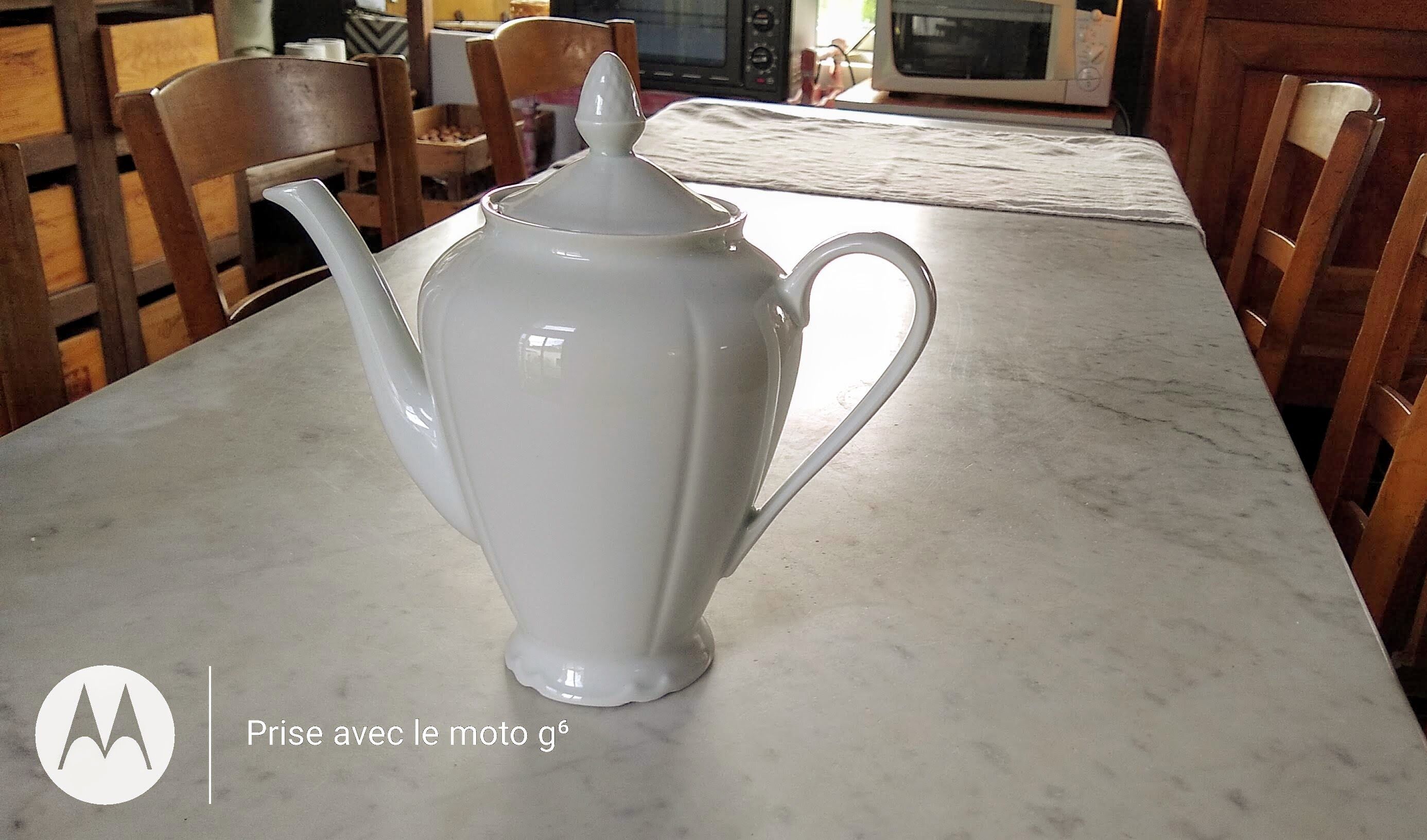 White porcelain teapot with acorn-shaped cap