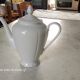 White porcelain teapot with acorn-shaped cap