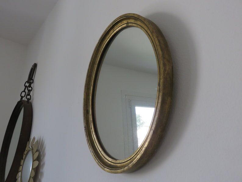 Old oval mirror in gilded wood 50s 60s