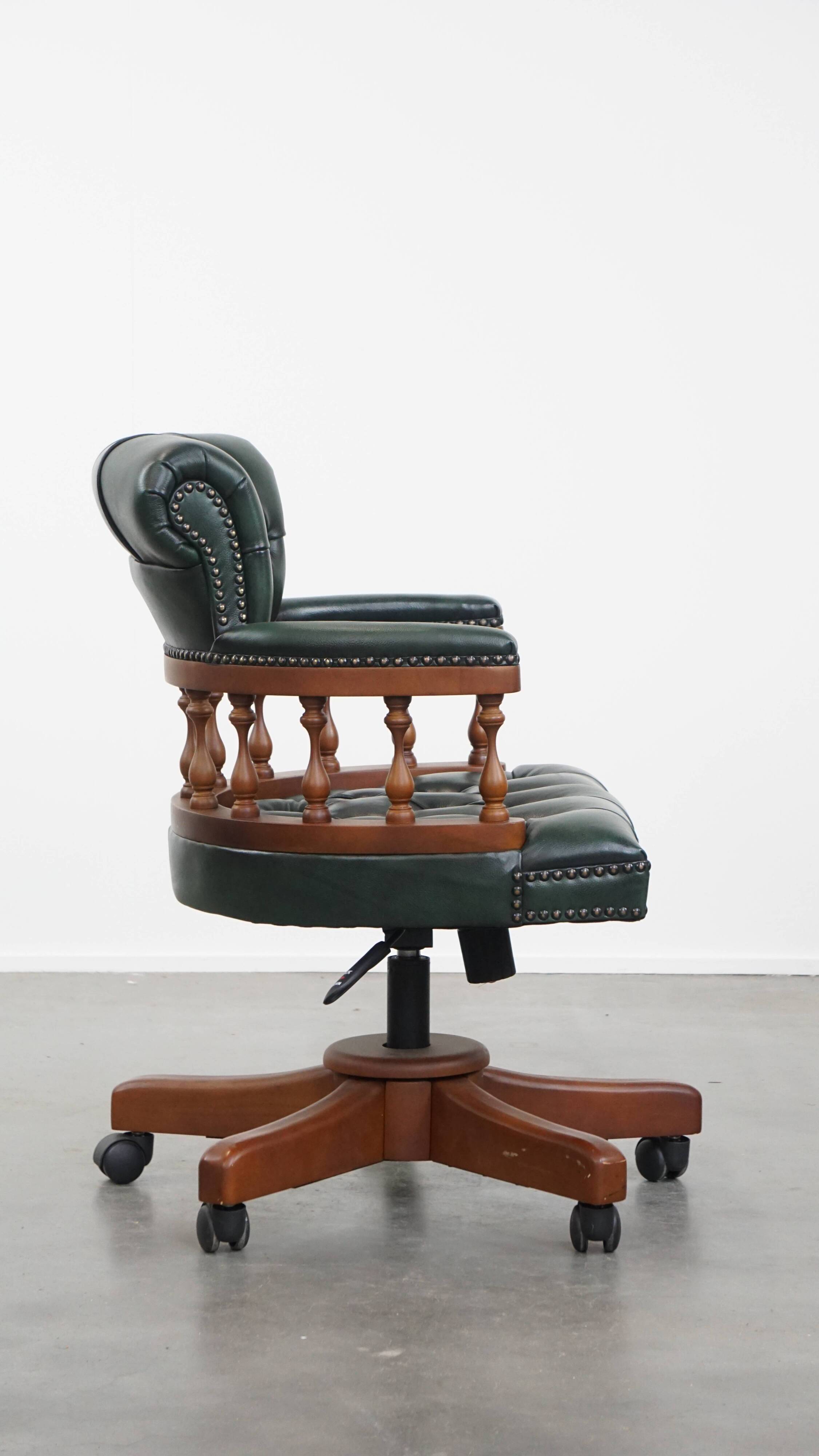 Dark green chesterfield office chair in cowhide leather on wheels