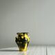 Small ceramic vase, yellow and green colors, artistic design,