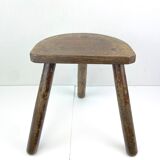 Ancient tripod milking stool - field theme, nature