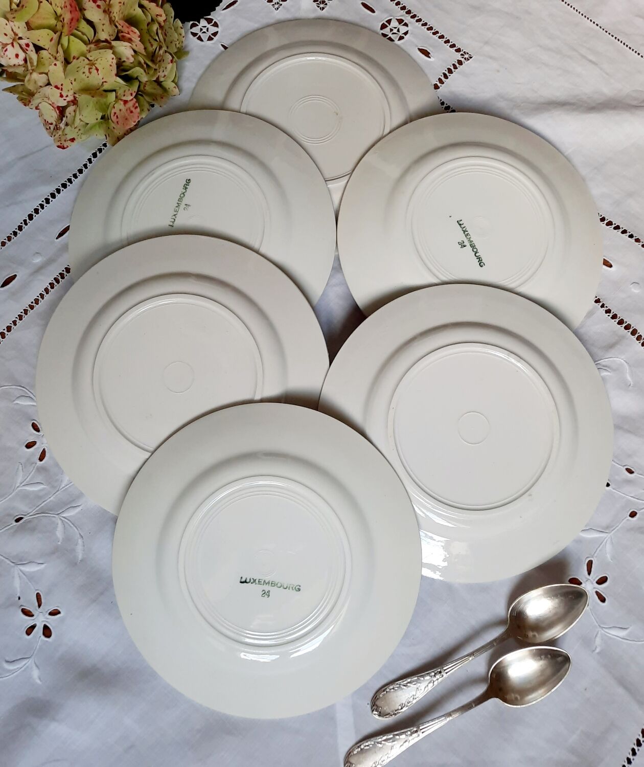 Mismatched old dessert plates accompanied by a dish