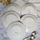 Mismatched old dessert plates accompanied by a dish