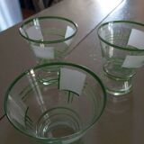 Carafe of green-striped liquor and its three glasses
