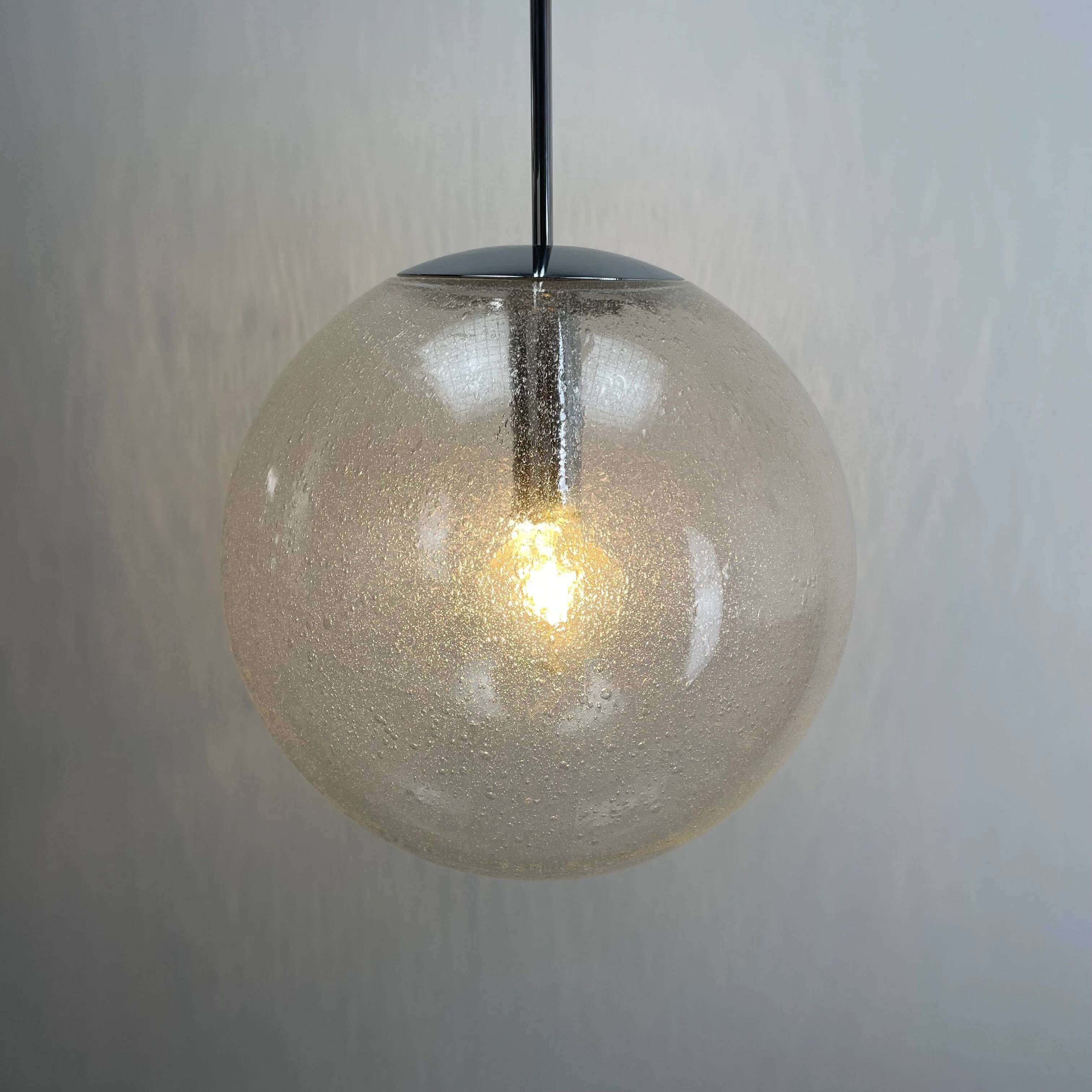 Large suspended lamp with a glass globe featuring bubbles by Peill & Putzler 1970.