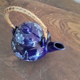 Small blue teapot and its wicker handle