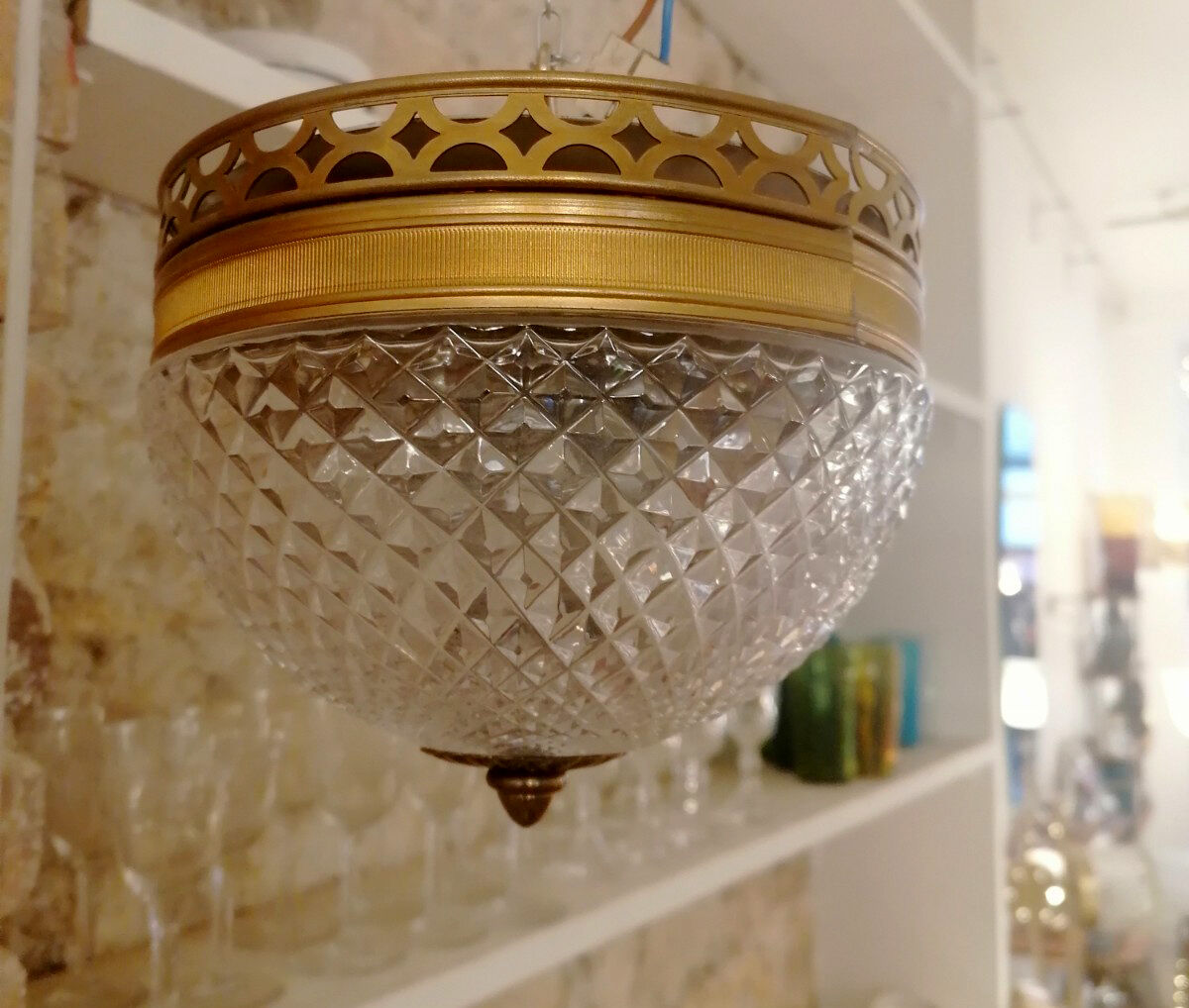 Pair of faceted glass ceiling lights and brass strapping, 1950.