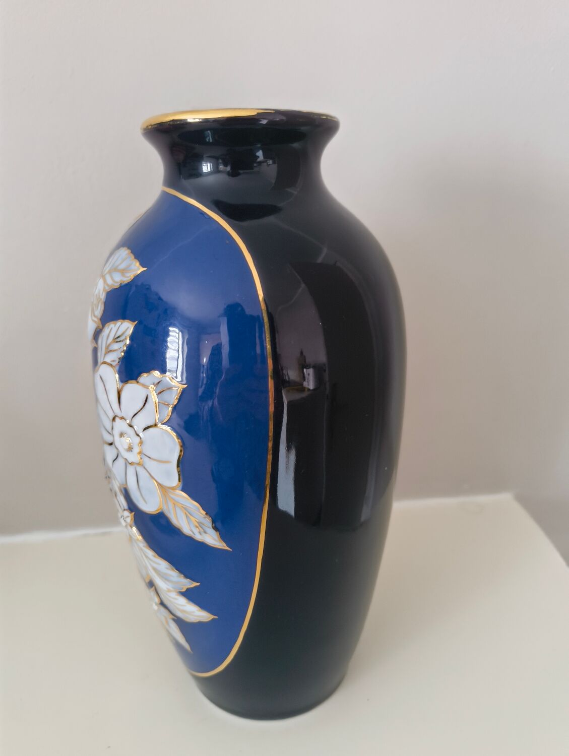 Cobalt blue porcelain vase from Limoges, France with floral pattern.