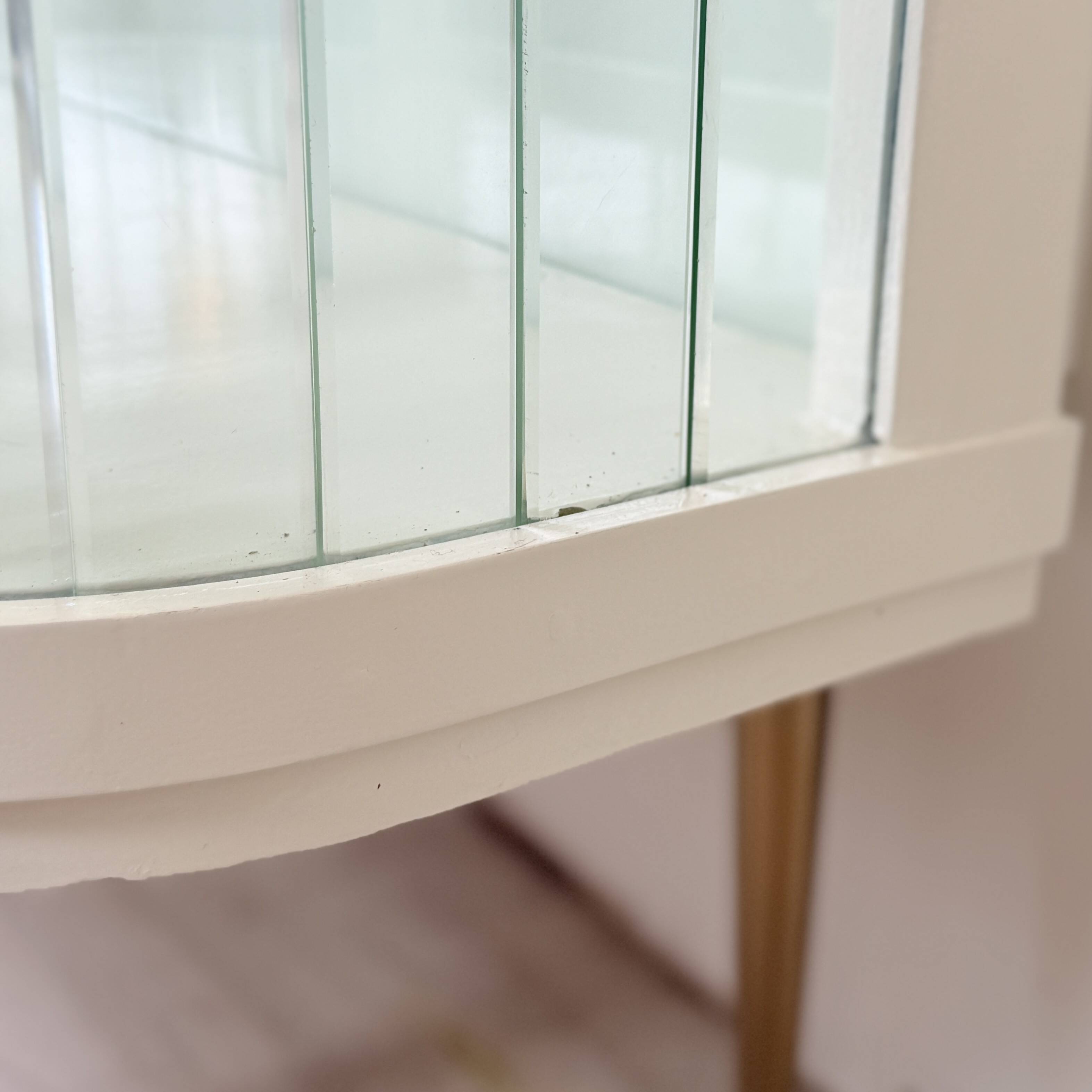 White vintage slatted display case on gold legs