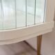 White vintage slatted display case on gold legs