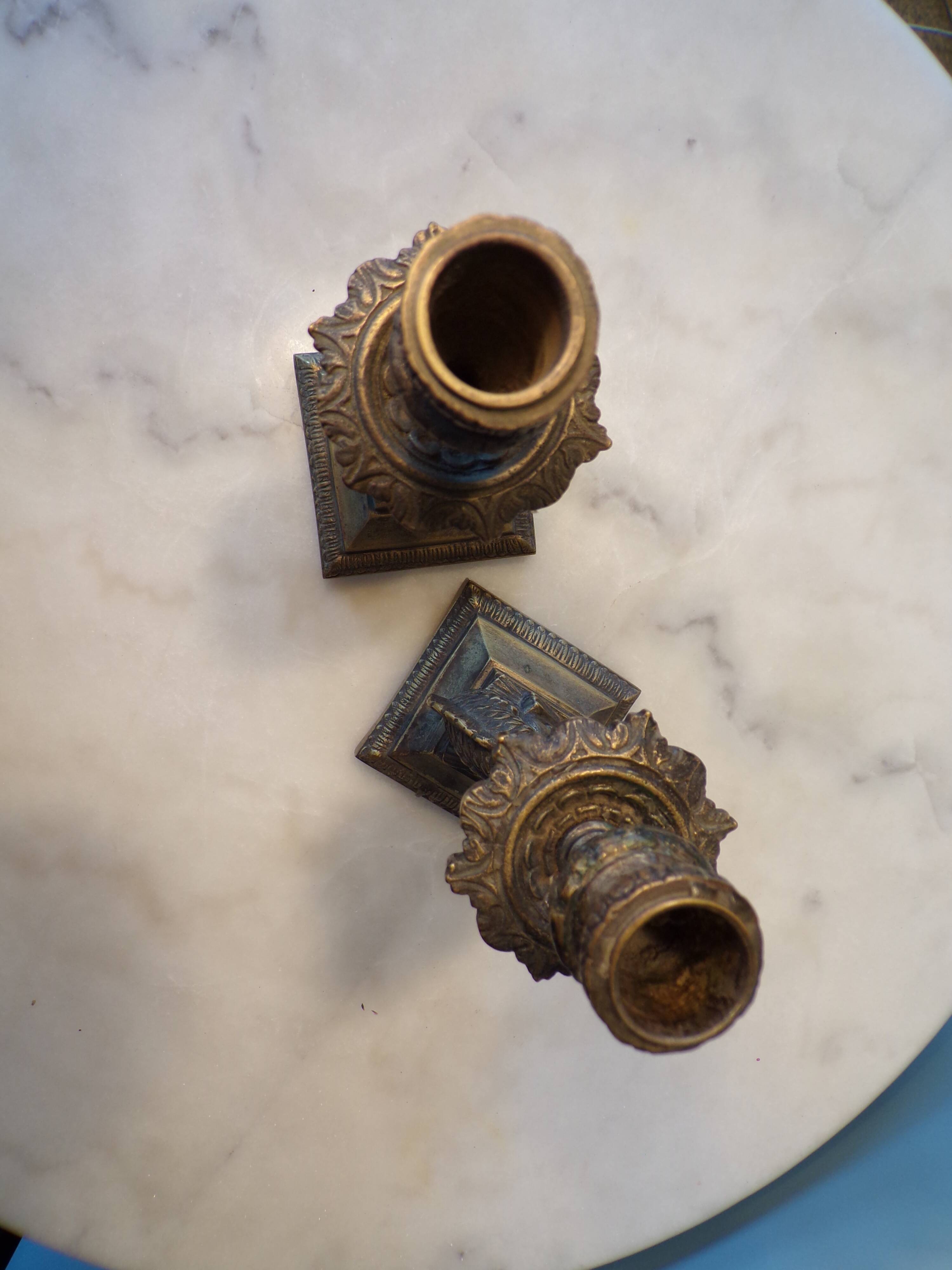 Pair of bronze dolphin candlesticks