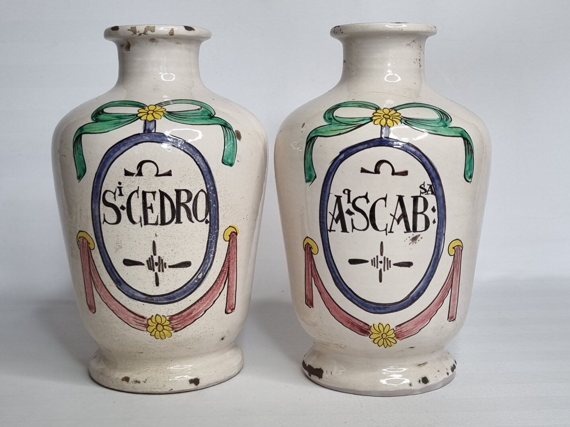 Pair of antique apothecary pots in glazed ceramic, decorated by hand