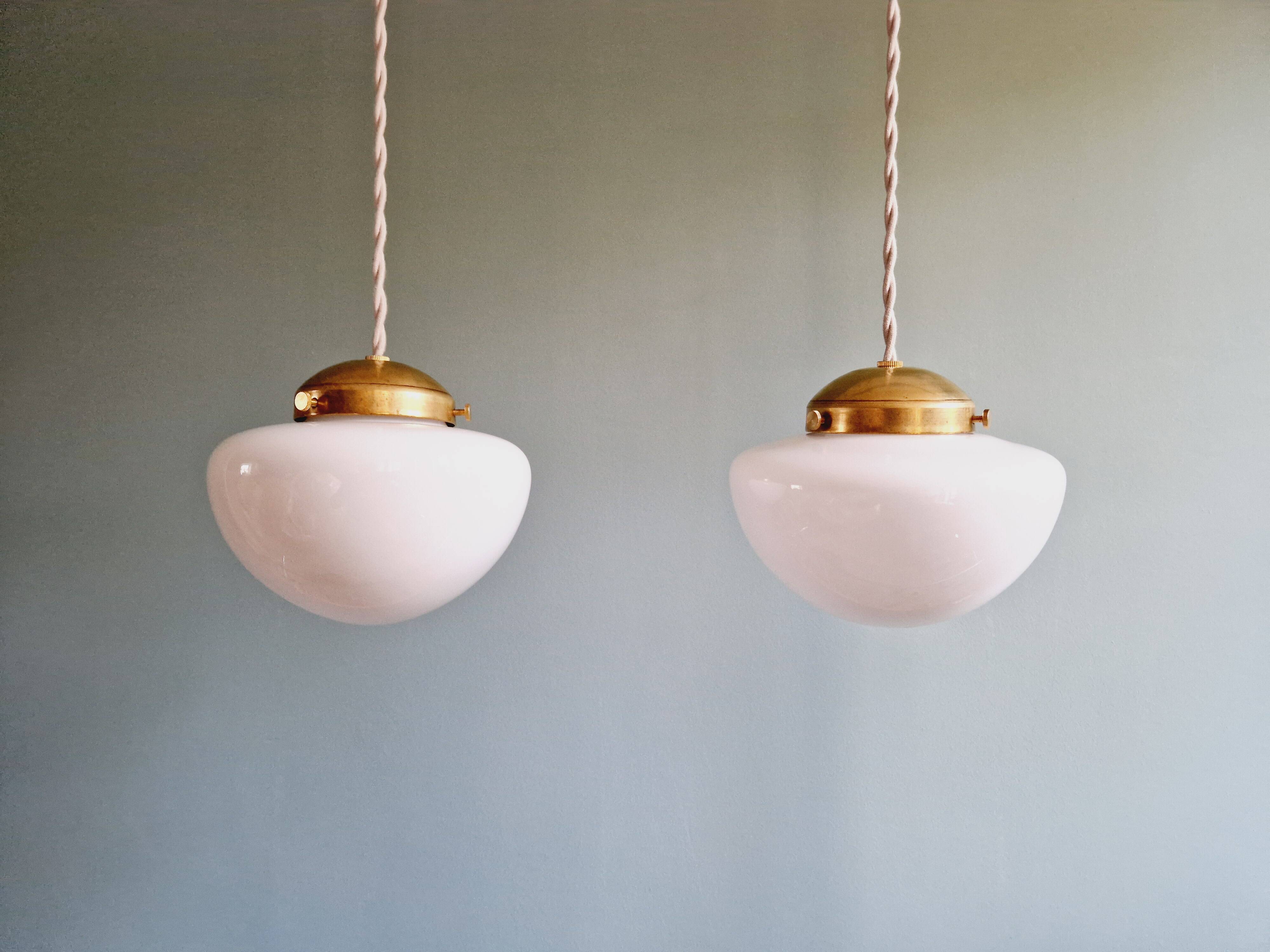 Duo of Art Deco suspensions in white opaline, 1920s-30s