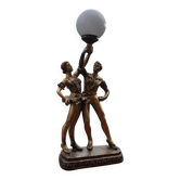 Art Deco desk lamp in gilded bronze with a white glass globe, featuring dancer figurines.