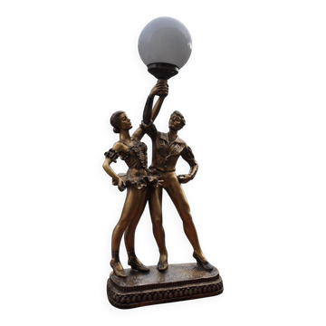 Art Deco desk lamp in gilded bronze with a white glass globe, featuring dancer figurines.