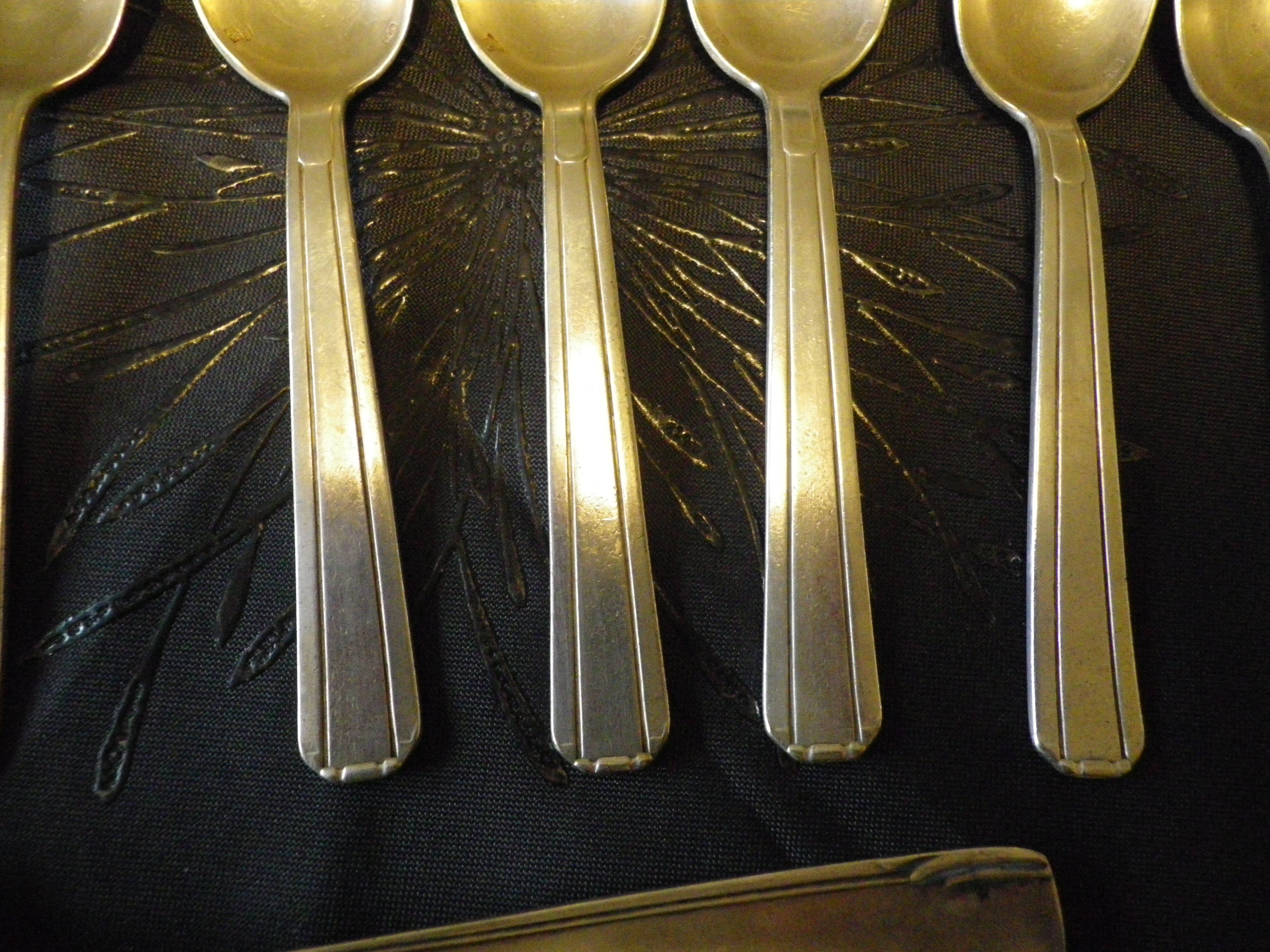 11 silver spoons with punches