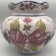 Round earthenware vase with polychrome floral motifs, signed