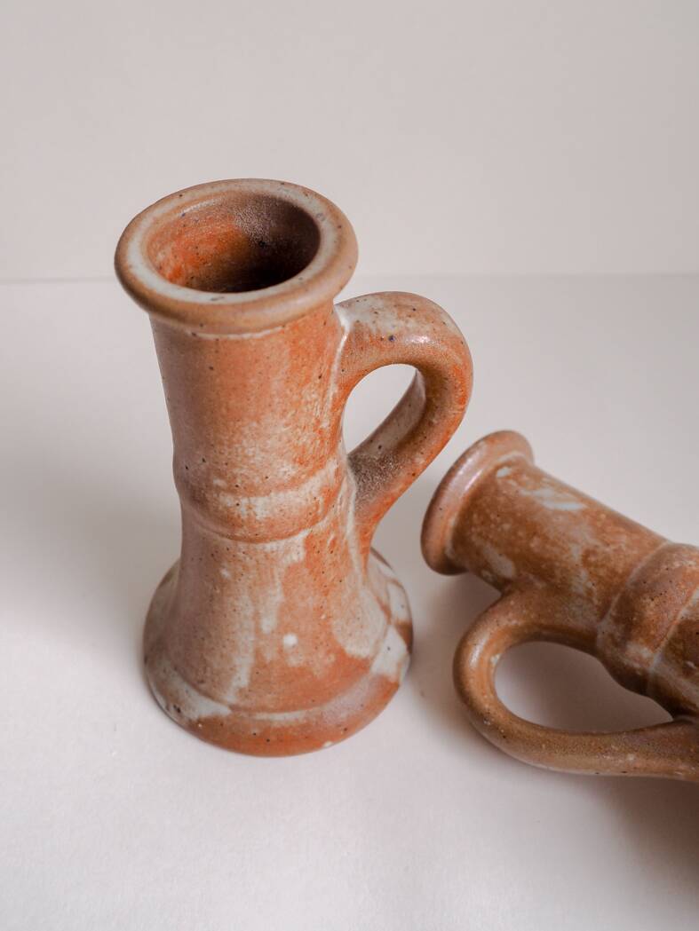 Set of two terracotta candle holders.