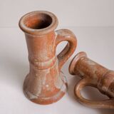 Set of two terracotta candle holders.