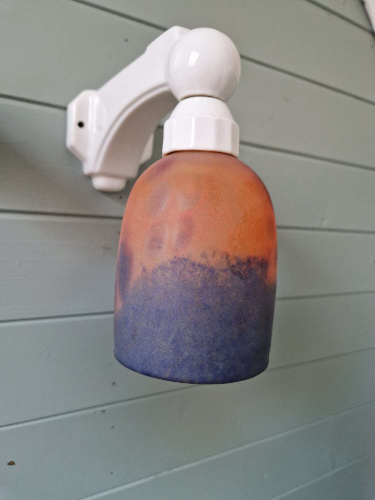 Pair of Art Deco wall sconces in multicoloured porcelain and frosted glass.