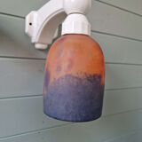 Pair of Art Deco wall sconces in multicoloured porcelain and frosted glass.