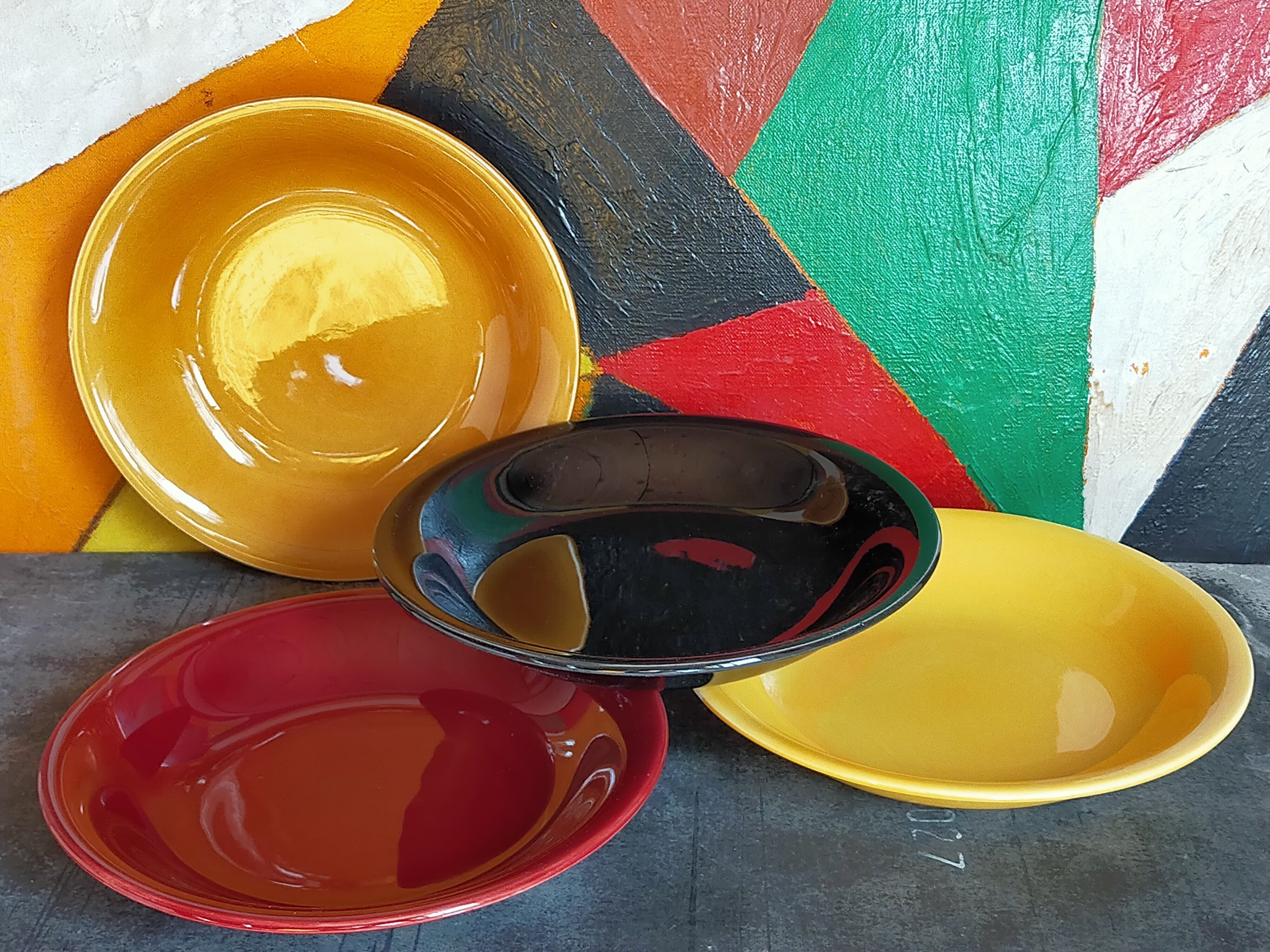 Four multicolored soup plates from the 1950s