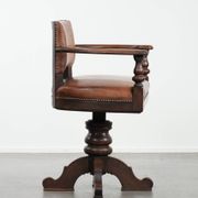 Elegant antique sheepskin leather desk chair with a heavy wooden frame
