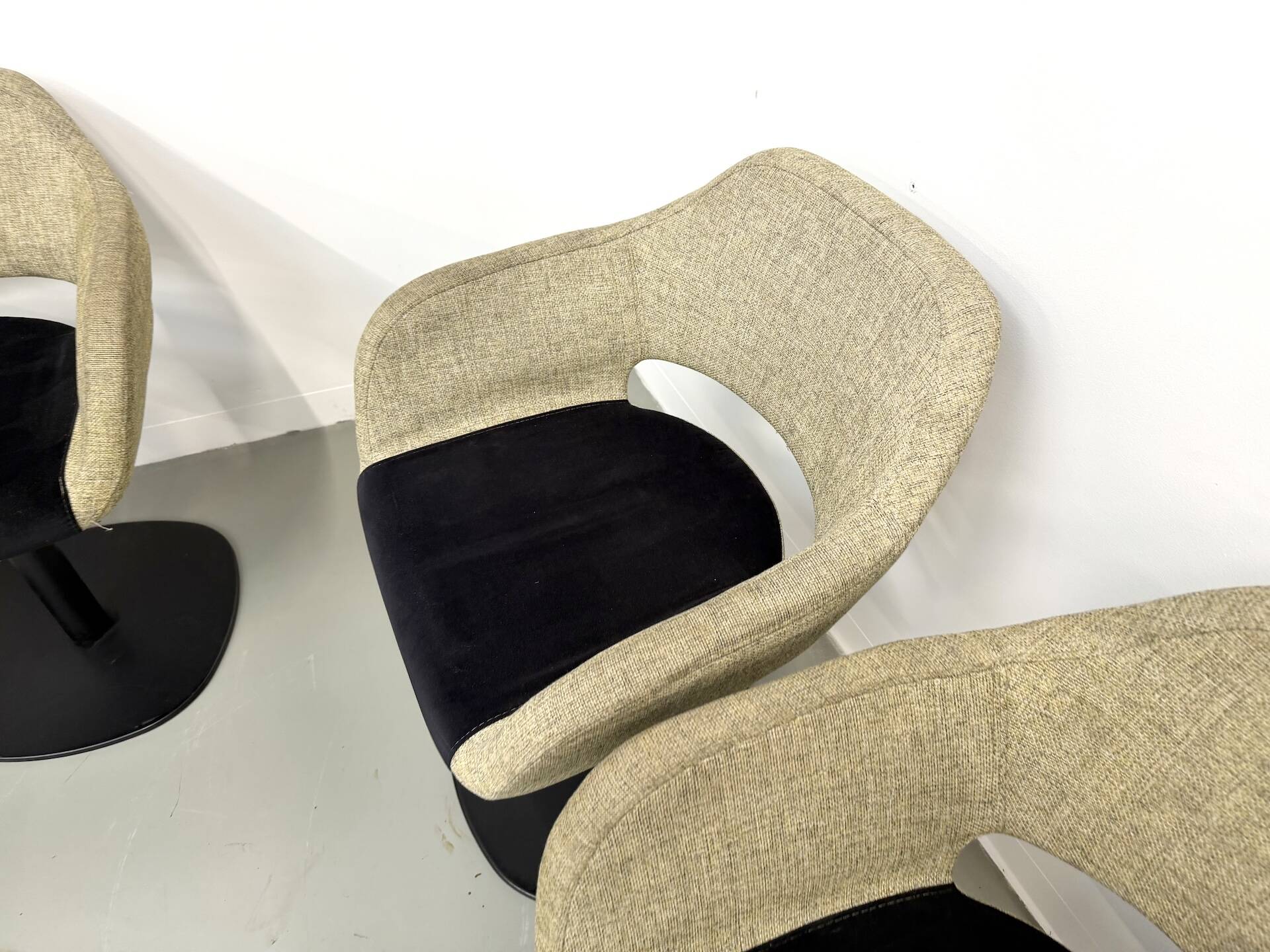 Series of six swivel chairs with an organic shell, patterned fabric and base.